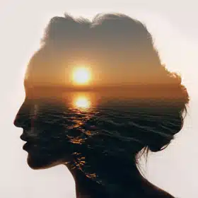 History of CBT and the ABCDE Model - CBT is based on the ideas of stoicism, which suggested that negative emotions were generated by errors of thinking. Image shows a calm sea superimposed on a woman's profile